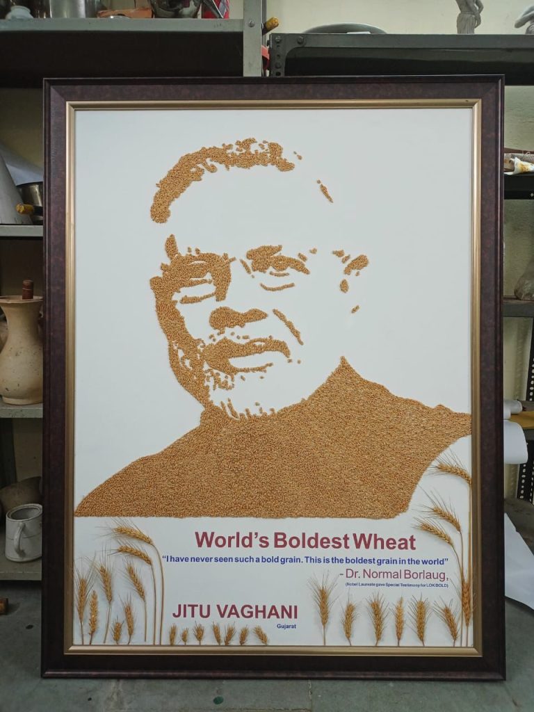 Education Minister Jitubhai Vaghani gifting Prime Minister Narendra Modi his portrait made of wheat grain at Bhavnagar