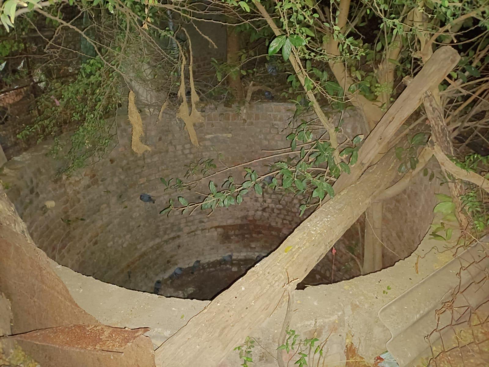 Animal lover rescuing a dog that fell into a well in Tarshingda Wadi area of Sihore.