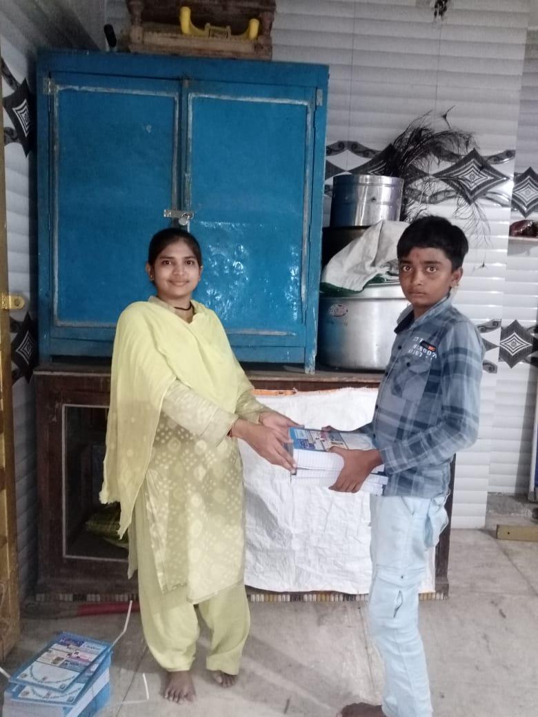 Notebook distribution by Bansiben Baraiah, a woman leader of Sihore Koli Samaj