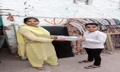Notebook distribution by Bansiben Baraiah, a woman leader of Sihore Koli Samaj