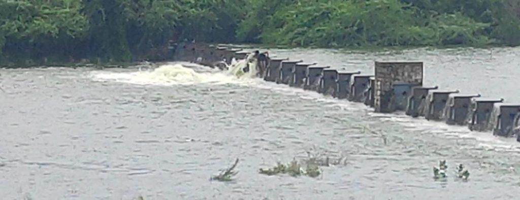 Three workers of Sihore Municipality walk in front of the waterfall and close the gates of the lake without any concern for life.
